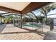 Screened pool and patio with brick pavers, creating a relaxing outdoor space at 180 Aurora Rd, Venice, FL 34293