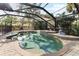 Inviting screened pool and patio area with a stone lion statue at 180 Aurora Rd, Venice, FL 34293