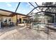 Expansive patio with a screened pool and outdoor kitchen at 180 Aurora Rd, Venice, FL 34293