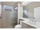 Clean bathroom with a glass shower, vanity, and a large mirror at 2037 Silver Palm Rd, North Port, FL 34288