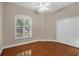 Bright bedroom with hardwood floors, large window with shutters, and double door closet at 2037 Silver Palm Rd, North Port, FL 34288