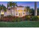 Elegant home exterior featuring a grand entrance and lush landscaping at 2037 Silver Palm Rd, North Port, FL 34288