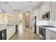 Bright kitchen with white cabinets, stainless steel appliances and tile flooring at 2037 Silver Palm Rd, North Port, FL 34288