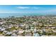 Aerial view showing a house with a pool in a residential area near the beach at 211 84Th St, Holmes Beach, FL 34217