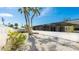 Backyard with palm trees and gravel at 211 84Th St, Holmes Beach, FL 34217