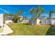 Backyard with grass, shed, and a white fence at 211 84Th St, Holmes Beach, FL 34217