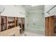 Bathroom with green tub, undergoing renovation, showing exposed plumbing at 211 84Th St, Holmes Beach, FL 34217