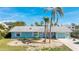 Front view of teal house with landscaping at 211 84Th St, Holmes Beach, FL 34217