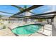 Serene kidney shaped pool under a screened patio cover at 211 84Th St, Holmes Beach, FL 34217