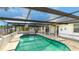 Refreshing kidney-shaped pool with a screened patio cover at 211 84Th St, Holmes Beach, FL 34217