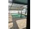 Relaxing kidney-shaped pool with a covered patio area at 211 84Th St, Holmes Beach, FL 34217