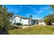 Side yard with grassy area and outdoor shower at 211 84Th St, Holmes Beach, FL 34217