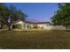 Well-maintained house with a lush lawn, and attractive landscaping at dusk at 2302 15Th W St, Palmetto, FL 34221