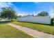 Landscaped side yard with white vinyl fence at 2302 15Th W St, Palmetto, FL 34221