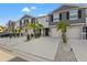 Three-unit townhome building with gray siding, two-car garages, and palm trees at 2850 Midnight Pearl Dr, Sarasota, FL 34240