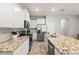 Spacious kitchen featuring granite island and white cabinets at 2850 Midnight Pearl Dr, Sarasota, FL 34240