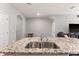 Kitchen island with granite countertop and double sink at 2850 Midnight Pearl Dr, Sarasota, FL 34240