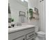 Modern bathroom with gray vanity, floating shelves, and toilet at 2930 61St E Dr, Ellenton, FL 34222