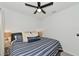 Comfortable bedroom with a striped comforter and nightstand at 2930 61St E Dr, Ellenton, FL 34222