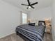 Bright bedroom with a king-size bed, carpet flooring, and ceiling fan at 2930 61St E Dr, Ellenton, FL 34222