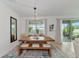 Bright dining room with a rustic wooden table and bench seating at 2930 61St E Dr, Ellenton, FL 34222