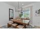 Elegant dining room featuring a rustic wooden table and modern lighting at 2930 61St E Dr, Ellenton, FL 34222