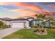 White one-story house with a two-car garage and palm trees in front at 2930 61St E Dr, Ellenton, FL 34222