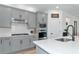 Modern kitchen with gray cabinets, quartz countertops and a gas cooktop at 2930 61St E Dr, Ellenton, FL 34222