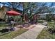 Community BBQ area with picnic tables and grills under shade umbrellas at 315 30Th W Ave # B210, Bradenton, FL 34205