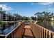 Wooden dock extending over calm water, offering scenic views of the community at 315 30Th W Ave # B210, Bradenton, FL 34205