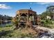 Relaxing gazebo with seating near a pond, perfect for enjoying the outdoors at 315 30Th W Ave # B210, Bradenton, FL 34205