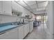 Neat kitchen with white cabinets and a blue countertop at 315 30Th W Ave # B210, Bradenton, FL 34205