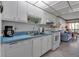 Fully equipped kitchen with white cabinets and blue countertops at 315 30Th W Ave # B210, Bradenton, FL 34205