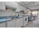 Efficient kitchen featuring white cabinets and blue countertops at 315 30Th W Ave # B210, Bradenton, FL 34205