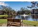 Peaceful lakefront view with a gazebo and bench, perfect for relaxation at 315 30Th W Ave # B210, Bradenton, FL 34205