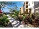 Landscaped walkway leading to condo building at 315 30Th W Ave # B210, Bradenton, FL 34205