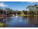 Serene pond with a fountain, enhancing the community's natural beauty at 315 30Th W Ave # B210, Bradenton, FL 34205