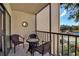 Screened balcony with small table and chairs overlooking a lake at 315 30Th W Ave # B210, Bradenton, FL 34205