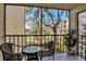 Screened balcony with small table and chairs overlooking a lake at 315 30Th W Ave # B210, Bradenton, FL 34205