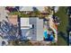 Overhead shot showcases pool, metal roof, outdoor entertaining space, canal, and dock at 320 Avenida Leona, Sarasota, FL 34242