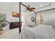 Bright bedroom features a canopy bed, wall mounted TV and ensuite bathroom at 320 Avenida Leona, Sarasota, FL 34242