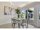 Cozy dining area with modern lighting, a glass table setting, and sliding doors to an outdoor patio at 320 Avenida Leona, Sarasota, FL 34242