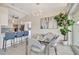 Bright dining area next to the kitchen, featuring a glass table, modern chandelier, and lush plant at 320 Avenida Leona, Sarasota, FL 34242