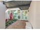 Close-up of a stylish front entrance featuring double glass doors, a decorative water feature, and brick paving at 320 Avenida Leona, Sarasota, FL 34242