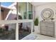 Bright foyer features a storage cabinet, mirror and large windows overlooking a charming outdoor fountain at 320 Avenida Leona, Sarasota, FL 34242