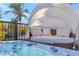 Relaxing hot tub with an canopy-covered outdoor daybed at 320 Avenida Leona, Sarasota, FL 34242