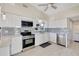 Modern kitchen featuring sleek white cabinetry, stainless steel appliances, and stylish tile backsplash at 320 Avenida Leona, Sarasota, FL 34242