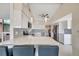 Spacious kitchen featuring white cabinets, stone countertops and a large island with bar seating at 320 Avenida Leona, Sarasota, FL 34242