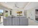 Comfortable living room featuring a modern sofa, TV, and natural light from large windows at 320 Avenida Leona, Sarasota, FL 34242