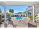 Backyard view of a pristine pool, hot tub, dolphin fountain, and outdoor seating area at 320 Avenida Leona, Sarasota, FL 34242